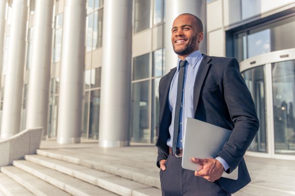 Man standing outside bank holding papers