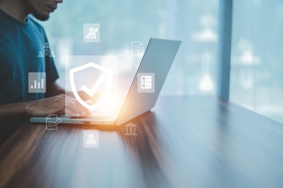 Man working on laptop with security icons